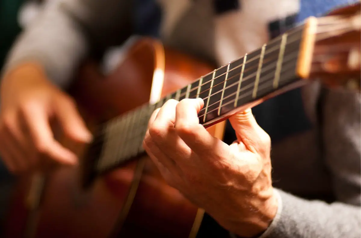 man playing acoustic guitar