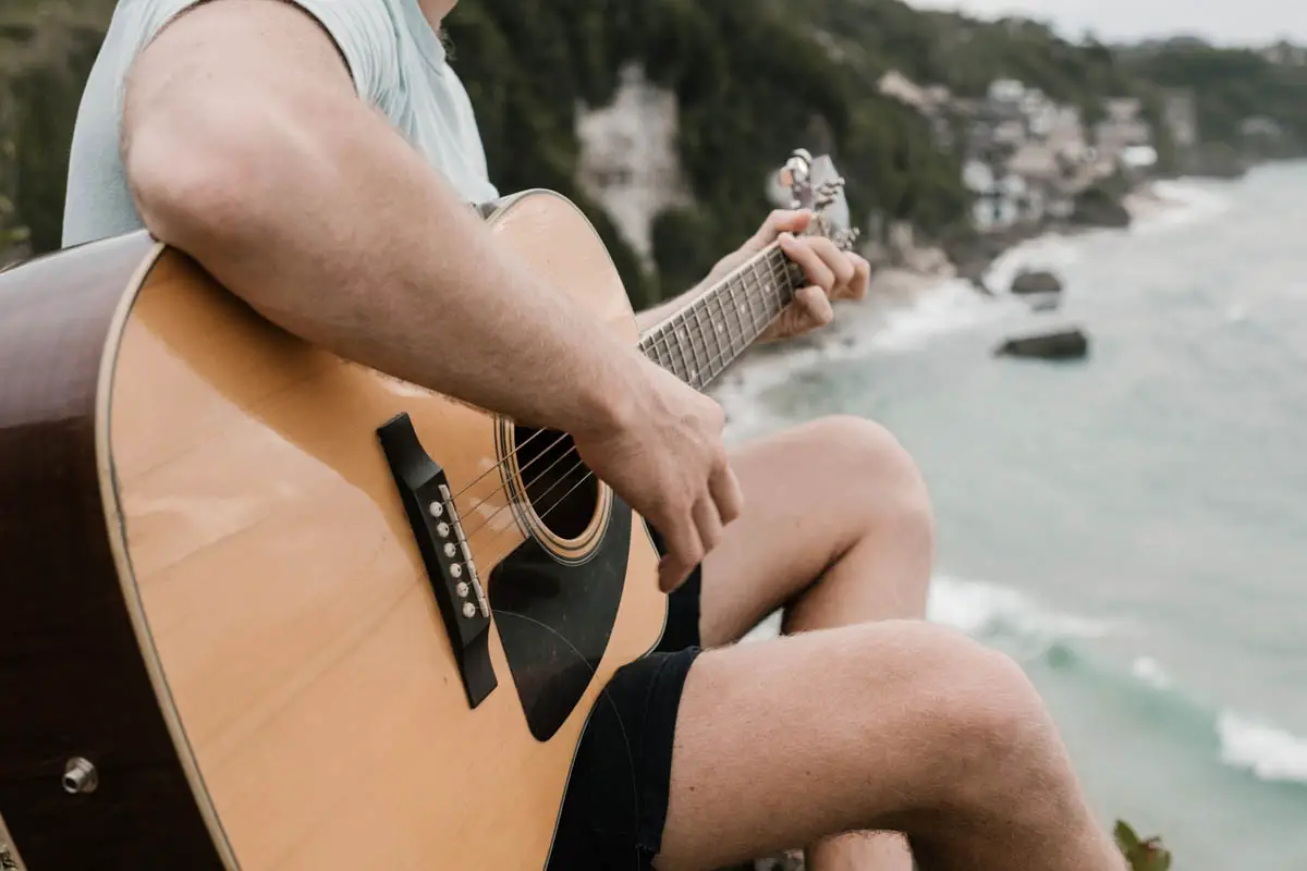 playing guitar near ocean