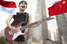 Asian goth girl playing electric guitar