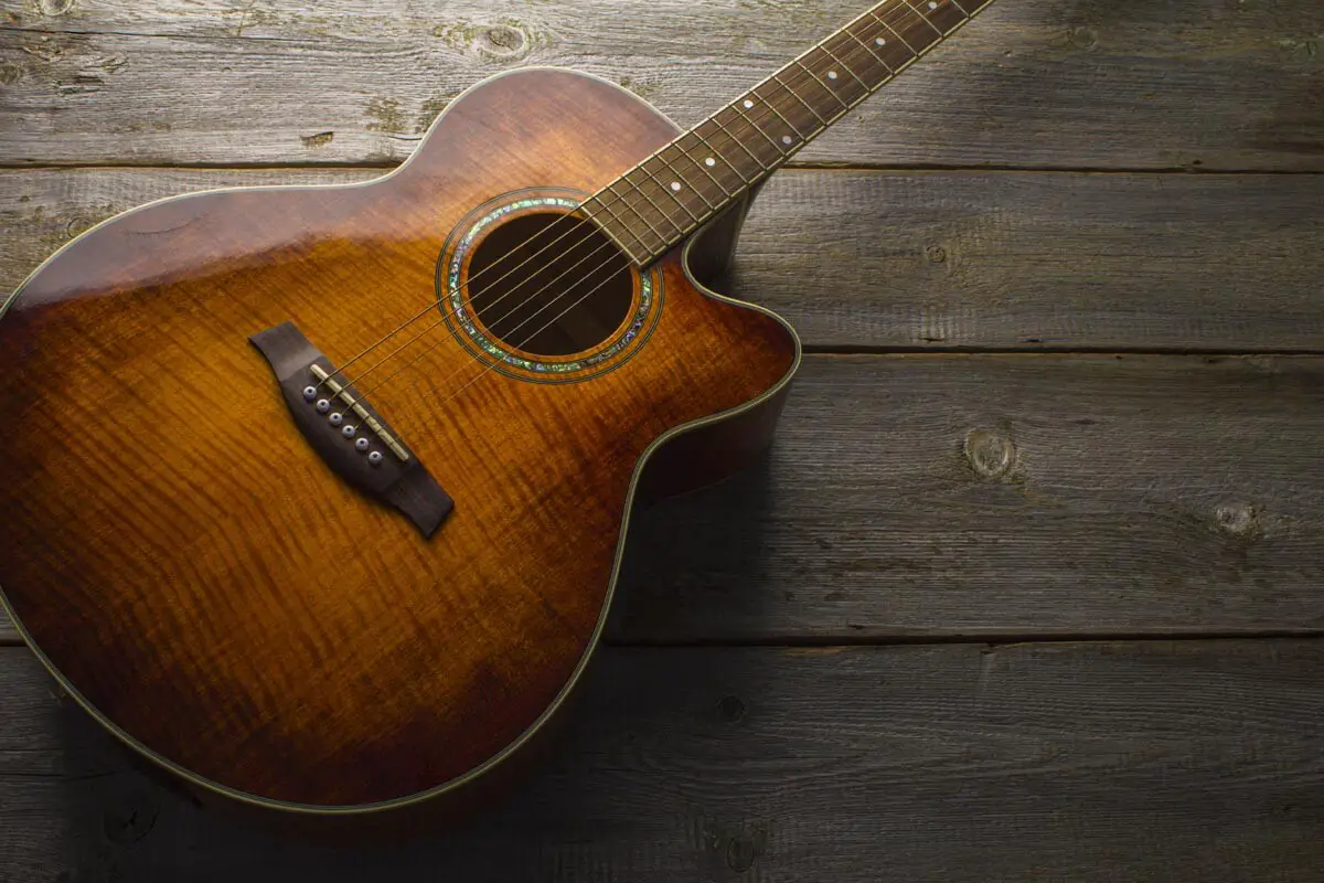 Glossy acoustic guitar with abalone rosette