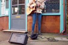 Busking Playing Acoustic Guitar Outdoors In Street