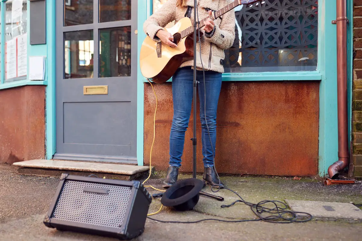 Busking Playing Acoustic Guitar Outdoors In Street