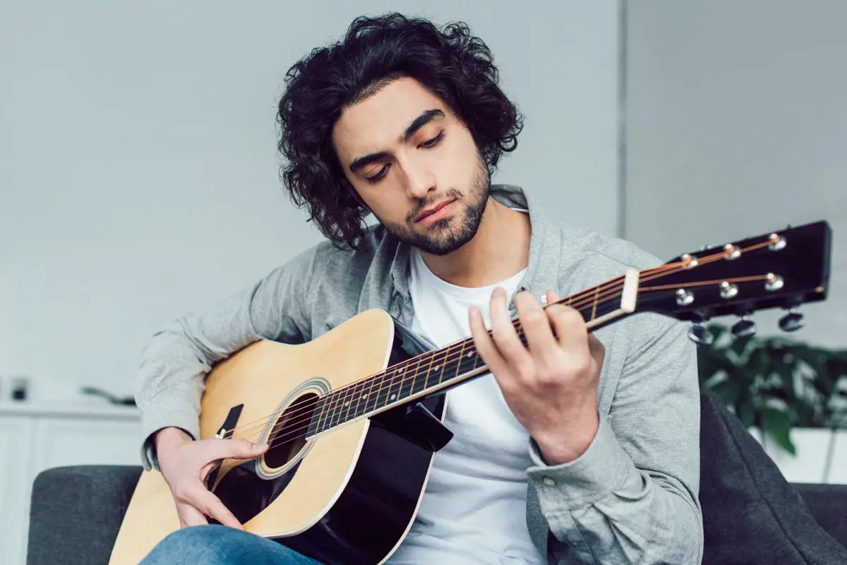 Young Man Learning Guitar