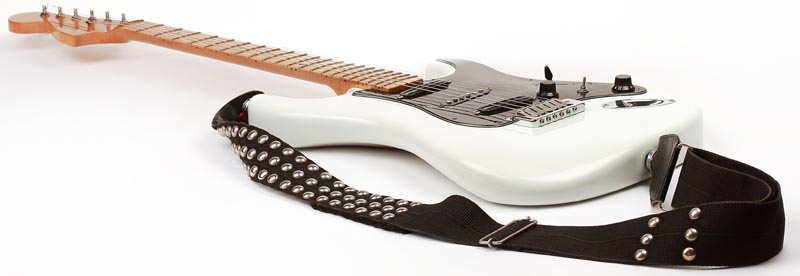 White electric guitar with studded strap
