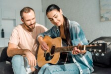 Mid aged couple learning guitar