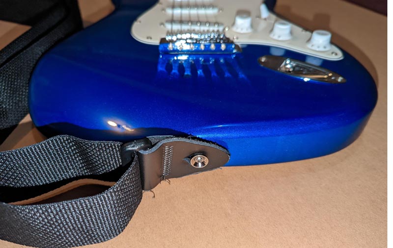 Strap on blue electric guitar