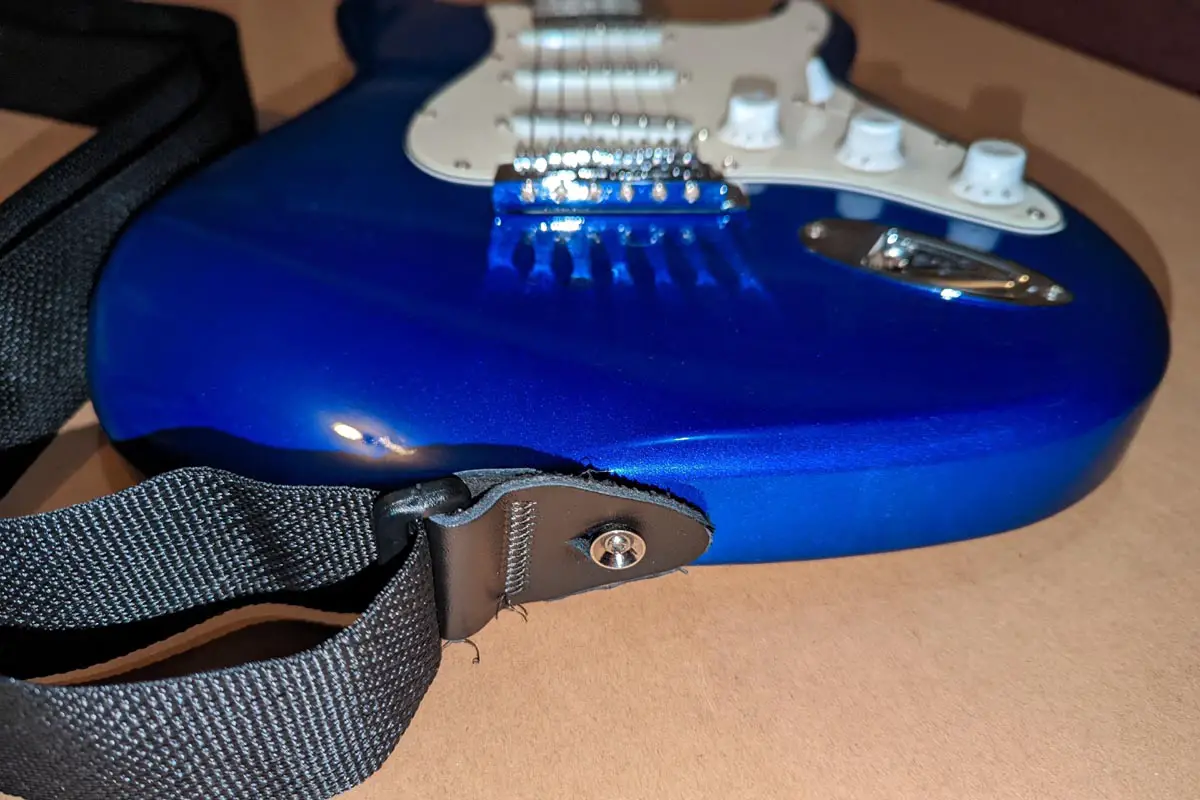 Webbing strap on blue electric guitar