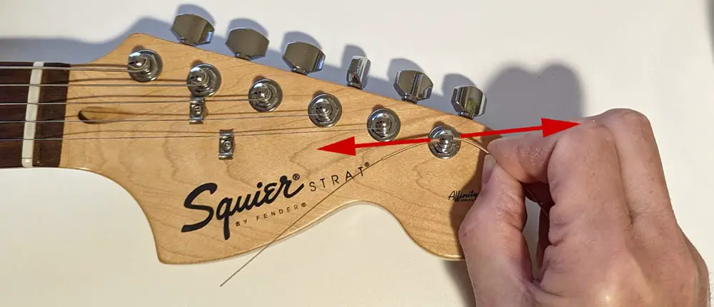 Filing guitar tuner post hole with an old string