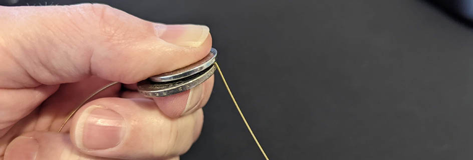 Cut guitar string with two coins