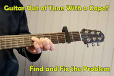 Playing a guitar with a capo on the second fret