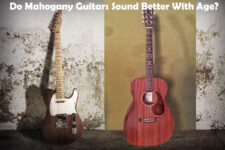 Mahogany electric and acoustic guitar leaning against old concrete wall