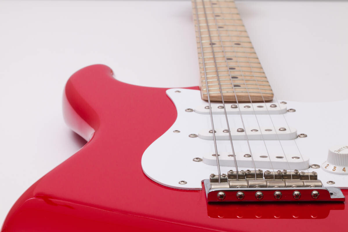 red electric guitar on a white table